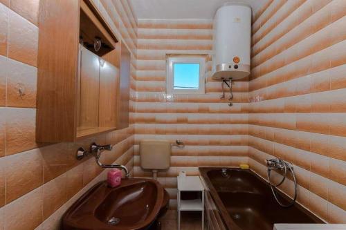 a small bathroom with a sink and a sink at Apartments by the sea Vinisce, Trogir - 16860 in Vinišće