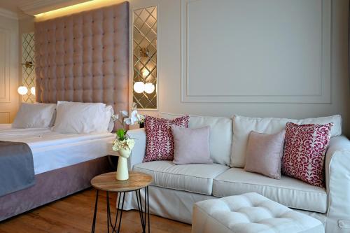 a living room with a bed and a couch at Casa di Fiore SPA and Medical Hotel, Mineral Pools & Private Beach in Kranevo