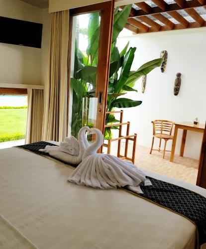 a swan decoration on a bed in a room at The Edicha in Lovina