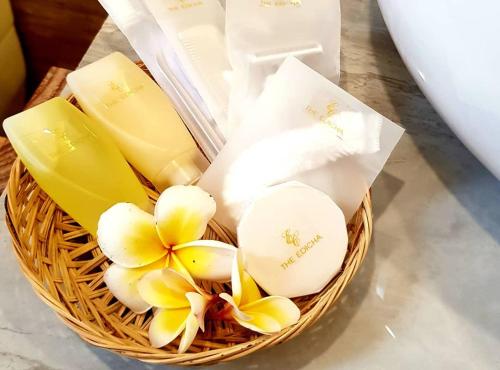 a basket with white and yellow flowers in it at The Edicha in Lovina