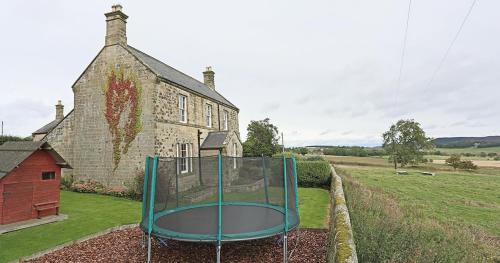 a basketball hoop in front of a building at Follions Farmhouse in Morpeth