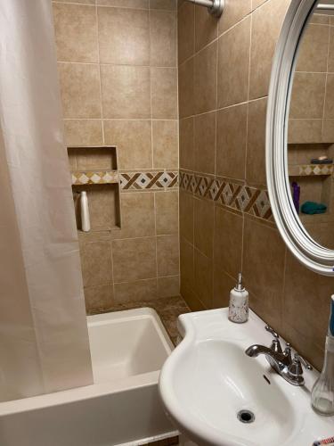 a bathroom with a sink and a bath tub at Sherman Hill Des Moines in Des Moines