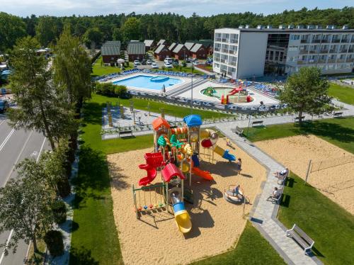 an aerial view of a playground with a water park at Zem-Tourist 250 M OD MORZA, ODKRYTY BASEN, PLAC ZABAW, PARKING, WYŻYWIENIE in Pustkowo