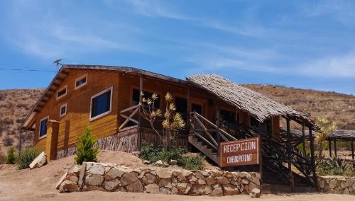 a wooden building with a sign in front of it at Maple Resort in Santa Rosa