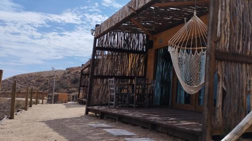 a building with a hammock hanging outside of it at Maple Resort in Santa Rosa