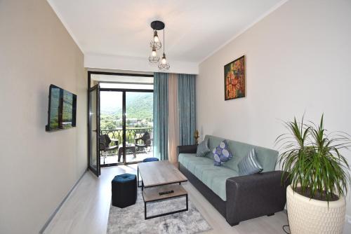 a living room with a couch and a table at Apartroom in Tsaghkadzor