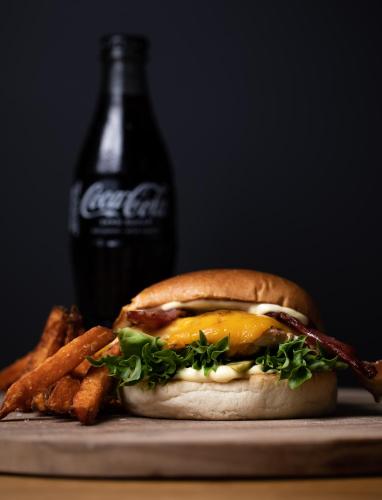a sandwich and french fries and a bottle of coke at Fugl Fønix Hotel in Etnesjøen