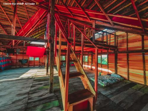 a room with bunk beds and a ladder in it at Secret Bay Panama in Arugam Bay