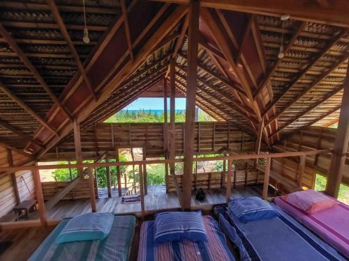 um quarto com telhado com várias camas em Secret Bay Panama em Arugam Bay