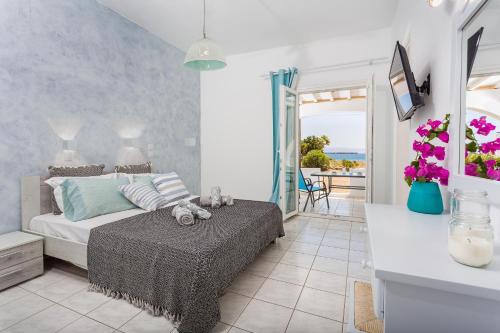 a bedroom with a bed and a view of the ocean at Villa Zeta in Chrissi Akti