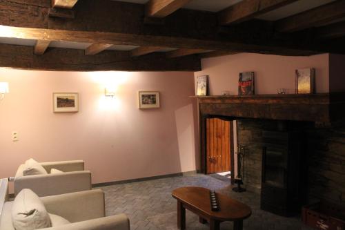 a living room with a couch and a fireplace at Chez Arsène in Bouillon