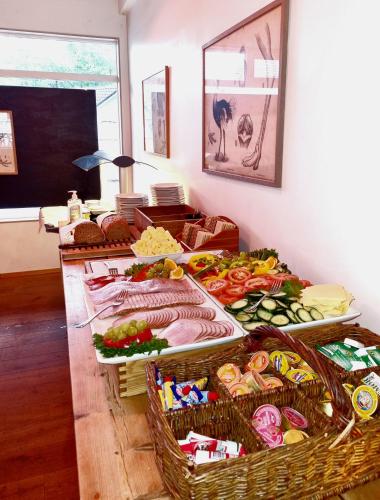 a table with many baskets of food on it at Fugl Fønix Hotel in Etnesjøen