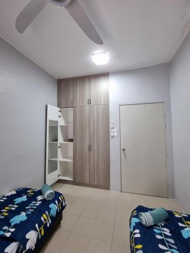 a bedroom with two beds and a closet at 3R2B Entire Apartment Air-Conditioned by WNZ Home Putrajaya for Islamic Guests Only in Putrajaya