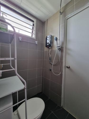 a bathroom with a shower with a toilet and a phone at 3R2B Entire Apartment Air-Conditioned by WNZ Home Putrajaya for Islamic Guests Only in Putrajaya