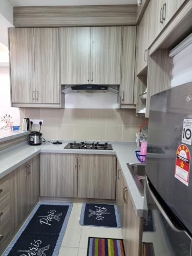 a kitchen with wooden cabinets and a stainless steel refrigerator at 3R2B Entire Apartment Air-Conditioned by WNZ Home Putrajaya for Islamic Guests Only in Putrajaya