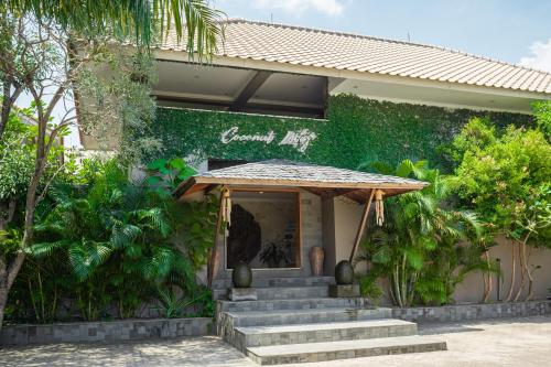 a building with stairs in front of a building at Coconut Lodge Resort in Jepara