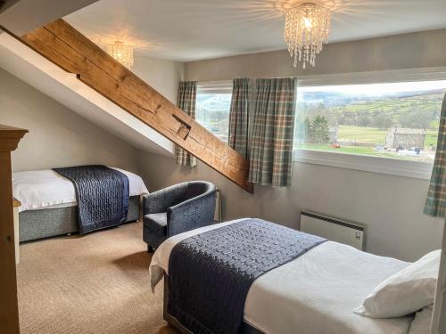 a bedroom with two beds and a stair case at Hackney House in Richmond