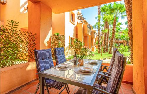 a table and four chairs on a patio with at Amazing Apartment In Los Alcázares in Los Alcázares