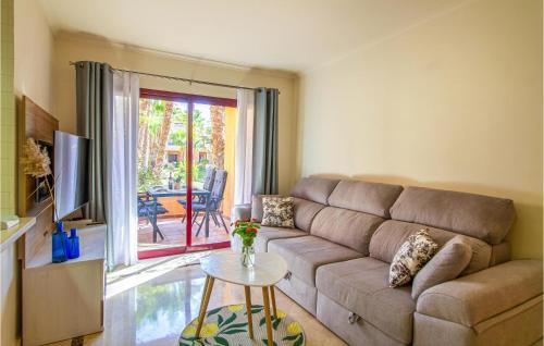 a living room with a couch and a table at Amazing Apartment In Los Alcázares in Los Alcázares