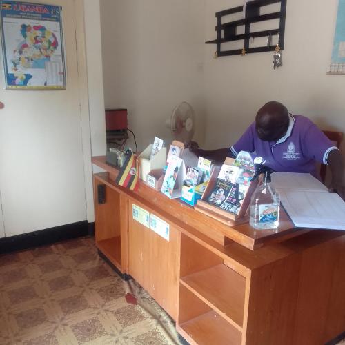 a man is standing at a counter in a room at Dream jet suites in Entebbe