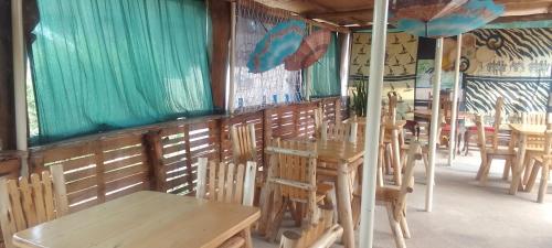 a row of tables and chairs in a restaurant at Dream jet suites in Entebbe