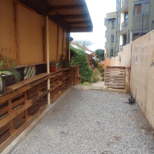 a patio with a fence and a building at Dream jet suites in Entebbe