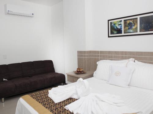 En eller flere senge i et værelse på Hotel Cinco Monteria