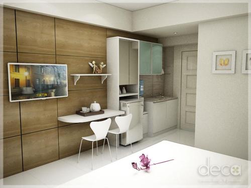 a kitchen with a table and a tv on a wall at Cosmy Tanglin Apartment in Surabaya