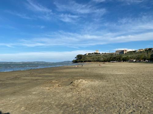 a beach with people laying on the sand at Casa Barbara in Sant Arcangelo