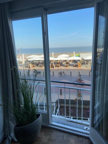 a view of the beach from a room with a window at Madame Mouette in Blankenberge