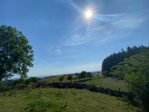 a view of a field with the sun in the sky at Lakeside Eco Pod in Oswestry