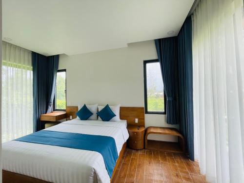 富國的住宿－Sao Beach Bungalow，一间卧室设有一张大床和两个窗户。