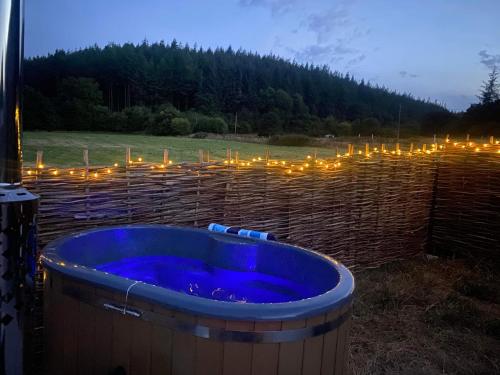 a jacuzzi tub with lights in a field at Roosters Retreat in Launceston