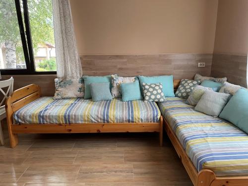 a couch with pillows on it in a room at Комплекс Омайник in Kalofer