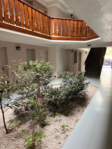 a building with a staircase and plants in a courtyard at Loc luz st sauveur 5 in Luz-Saint-Sauveur