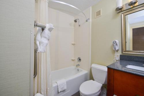 a bathroom with a tub and a toilet and a sink at Holiday Inn Express Towson- Baltimore North by IHG in Towson