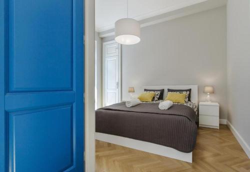 a bedroom with a bed and a blue door at Nice Place in Krakow