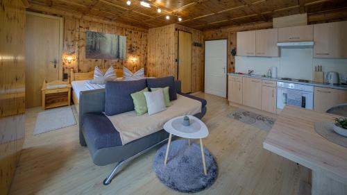 a living room with a couch and a kitchen at Haus Egger in Kartitsch