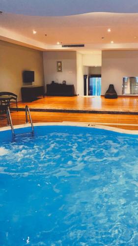 a large blue swimming pool in a hotel room at Hotel & Resort Golden Marina Yanbu in Yanbu