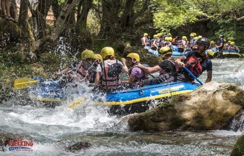 a group of people in a raft in a river at Stonehouse dome Lagadia in Lagadia