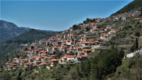 a village on the side of a mountain at Stonehouse dome Lagadia in Lagadia