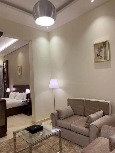 a living room with a couch and a bed at Hotel & Resort Golden Marina Yanbu in Yanbu