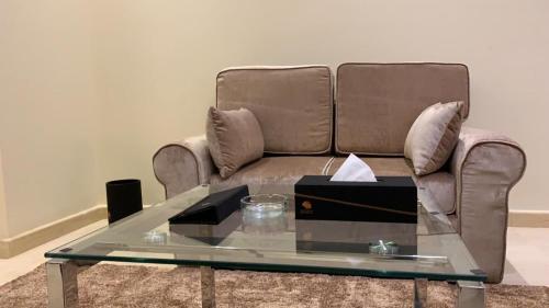 a living room with a couch and a glass table at Hotel & Resort Golden Marina Yanbu in Yanbu