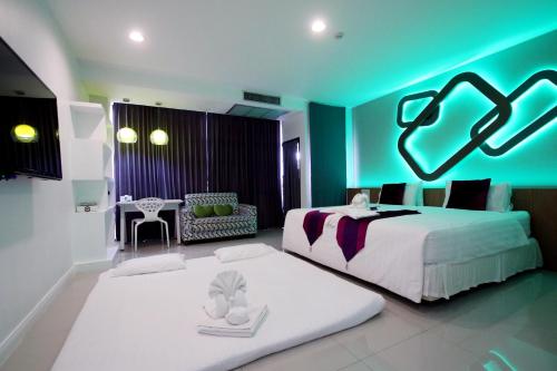 a bedroom with a large white bed and a blue ceiling at Phitsanulok United in Phitsanulok