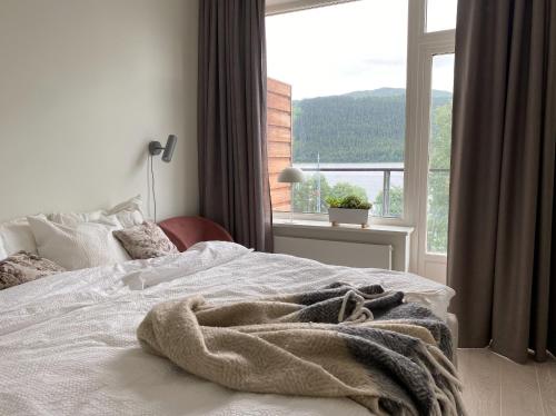 a bedroom with a bed with a large window at Åre Travel - VM huset in Åre