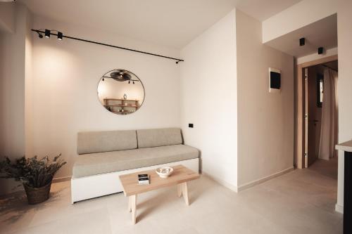 a living room with a couch and a table at Om Living Afitos in Afitos