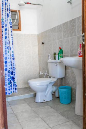 a bathroom with a toilet and a sink at SeaEsta studio Shanzu Serena in Mombasa