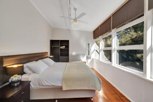 a bedroom with a bed and a large window at Harmony at Tower Hill in Koroit