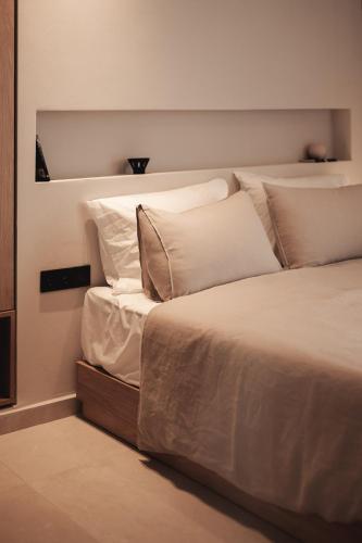 a bedroom with a bed with white sheets and pillows at Om Living Afitos in Afitos