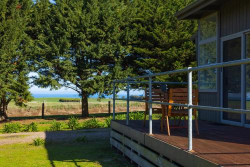 a wooden bench sitting on the porch of a house at Harmony at Tower Hill in Koroit
